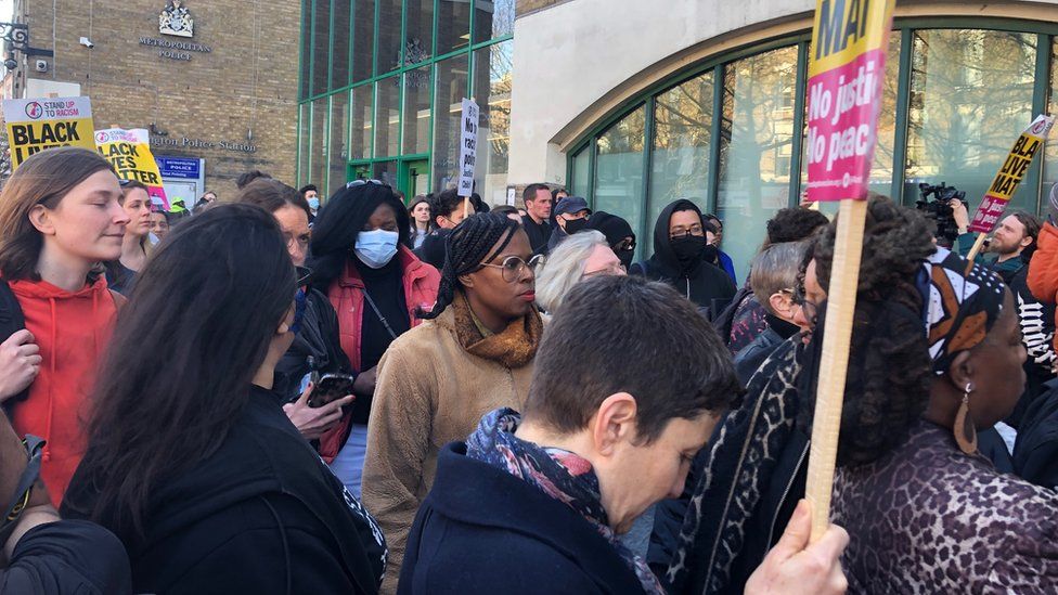 People protesting the teenager's treatment outside an east London police station