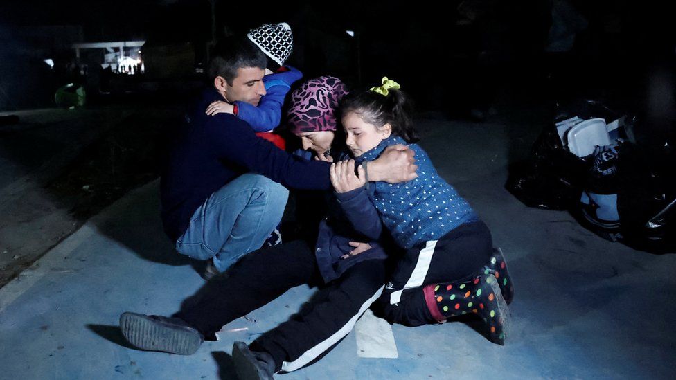 People react after a 6.4 magnitude earthquake hit in Antakya, southern Turkey, on Monday