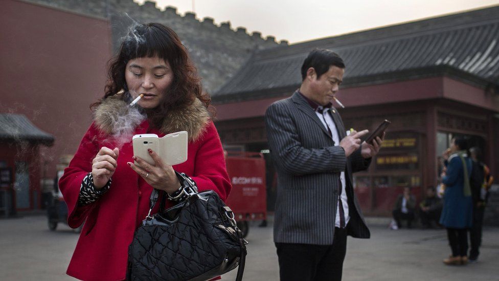 People using mobile phones in China