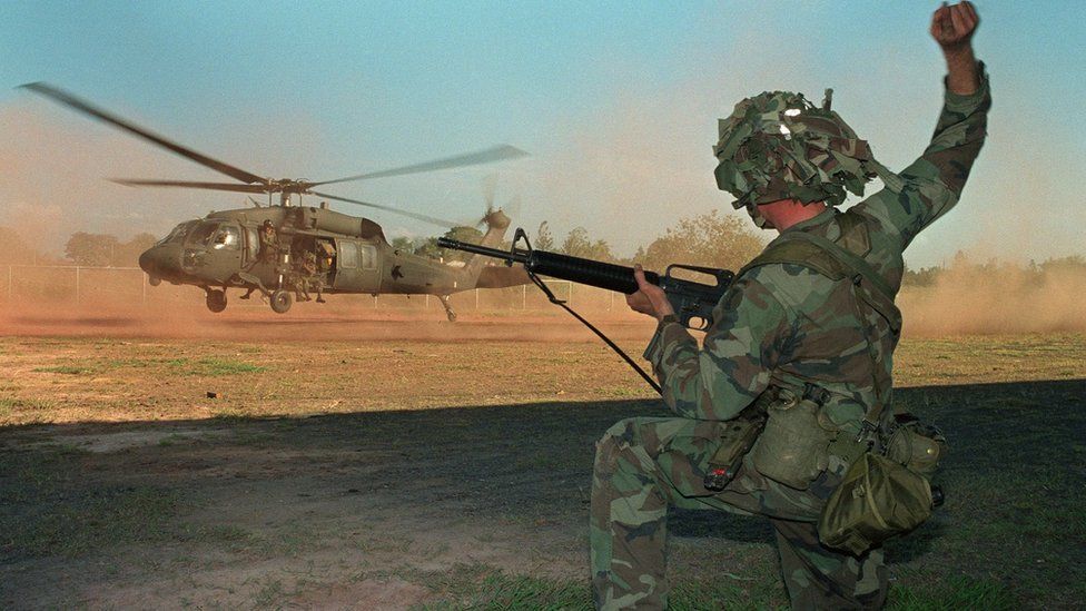 A US soldier guides a military helicopter during an operation against a military command post loyal to General Manuel Noriega on 23 December, 1989.