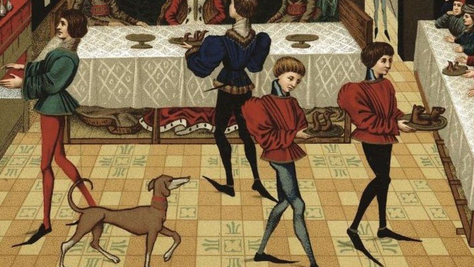 Servants wearing long pointed shoes serving French noblewomen, 15th Century