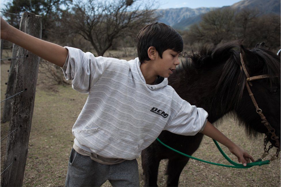 Oscar's youngest son, Pincén, playing with his pony