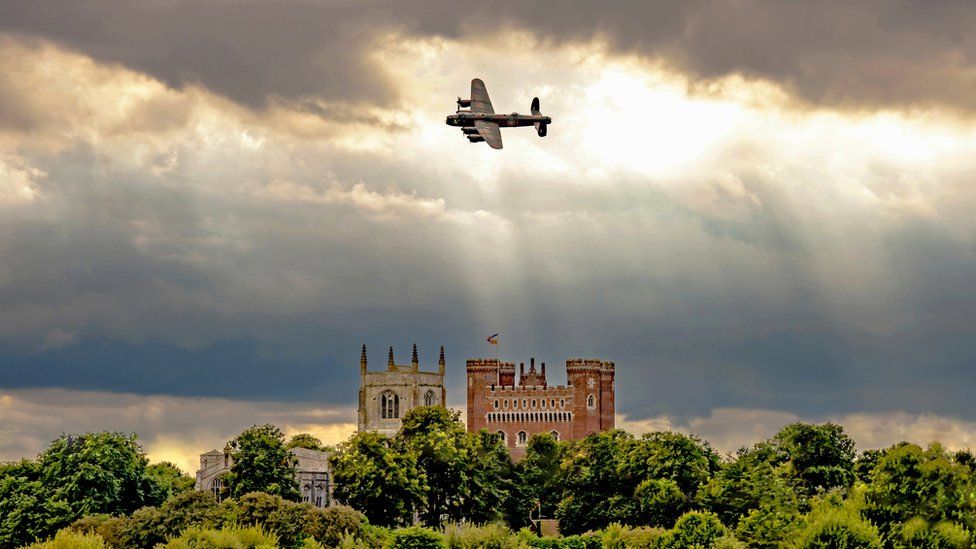 Lancaster bomber flying over Tattershall Castle