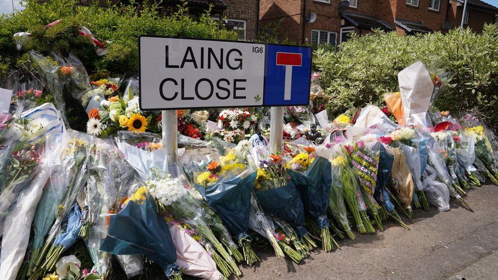 Bunches of flowers left by the road sign for Laing Close, close to where Daniel was attacked