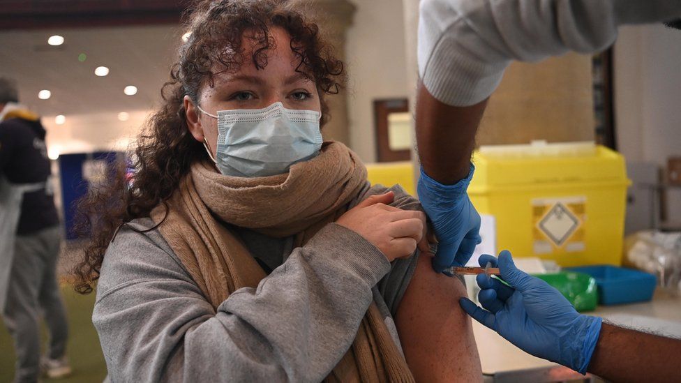 Woman receives vaccine in London