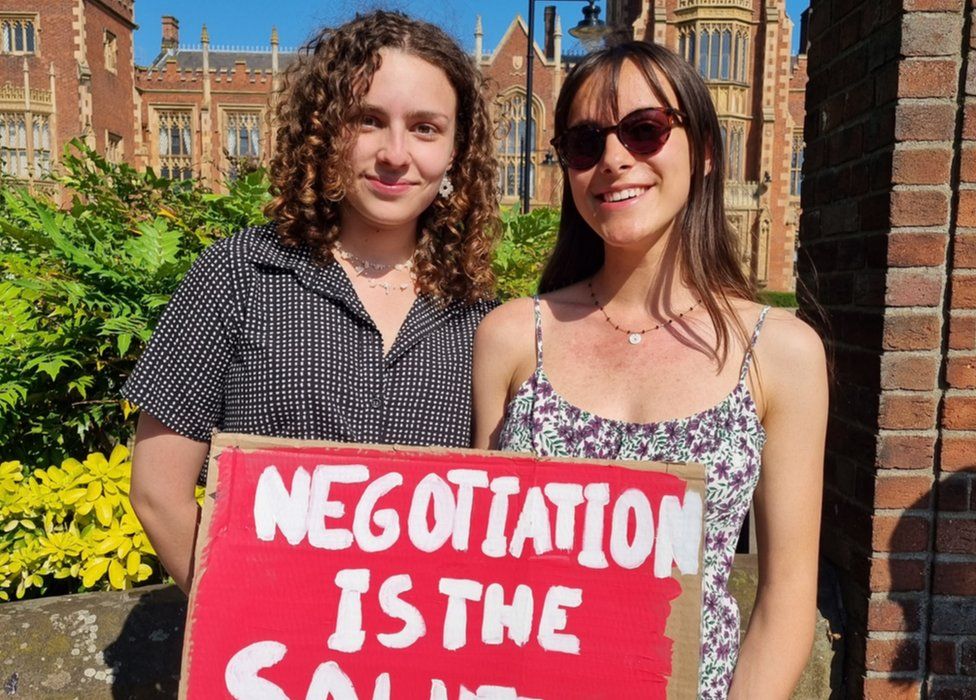 Sophia Kamal (20) and Solyane Michaut (21) stand outside Queen's University.