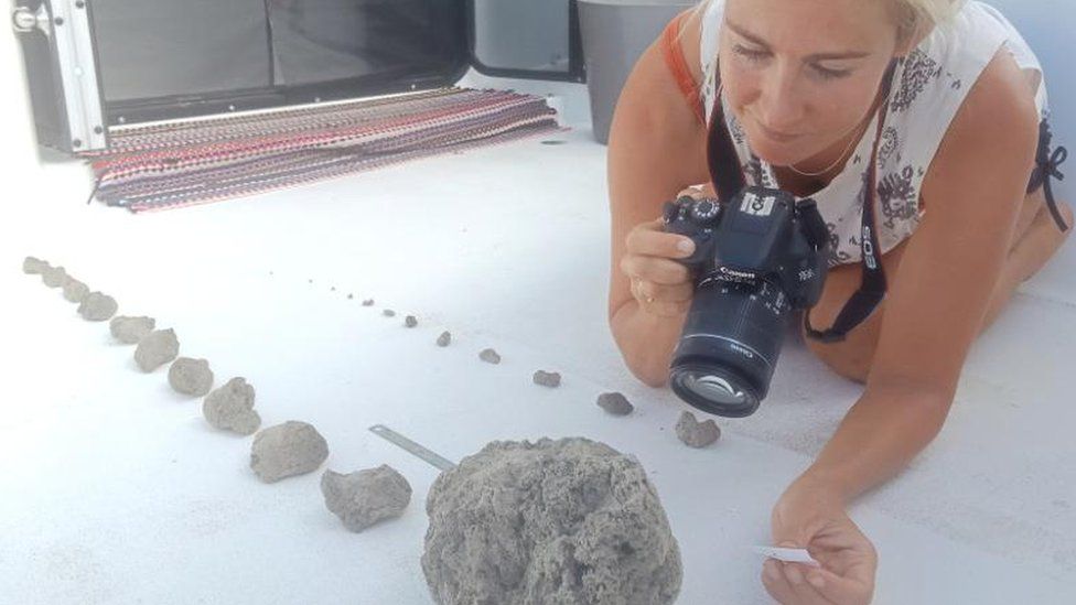 Larissa Brill takes photos of the pumice samples