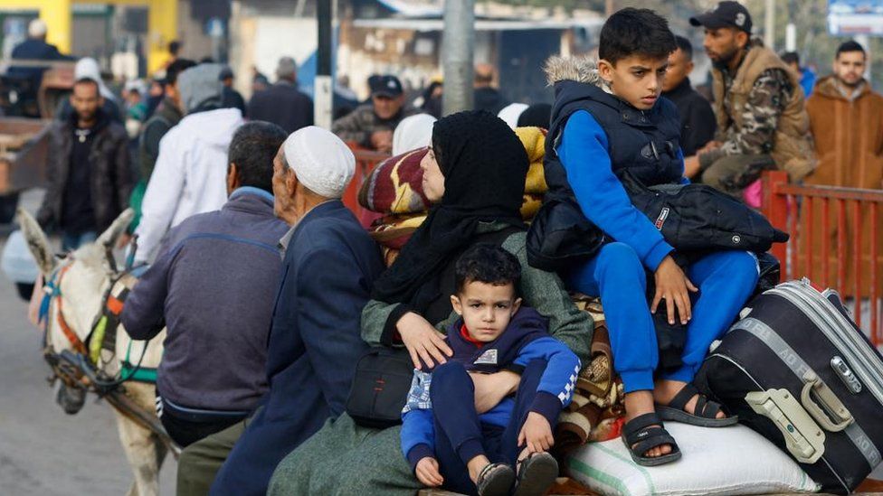 Palestinians boys sit on a trailer in the eastern part of Khan Younis city, Gaza