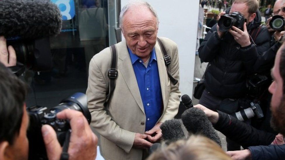 Ken Livingstone surrounded by reporters and photographers