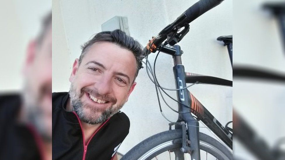 man take selfie next to bike