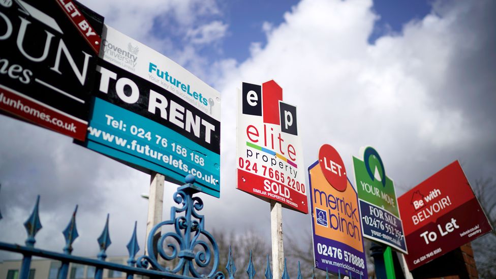 To rent signs against a blue sky and clouds