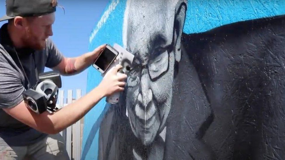 Graffiti artist Tee2Sugars completes a mural in Merthyr Tydfil to Capt Tom Moore