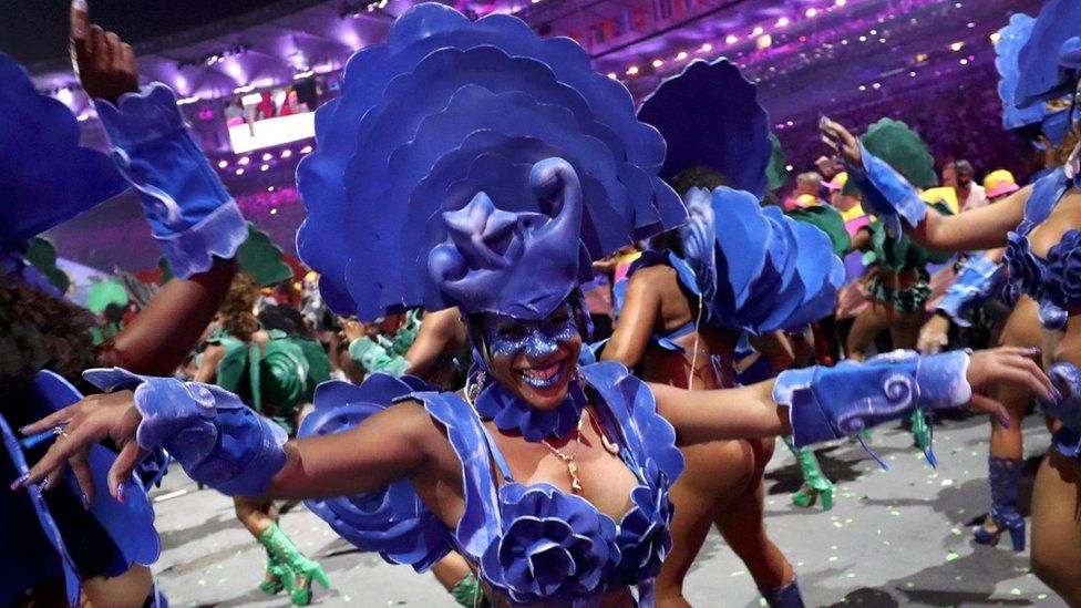 Woman in blue costume dances as part of the opening ceremony in Rio (5 August 2016)