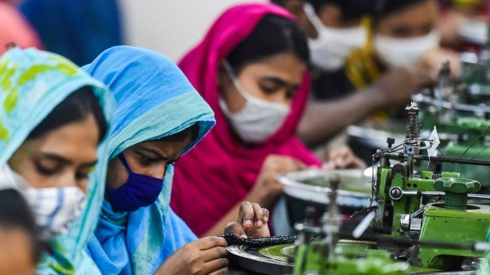 Labourers work in a garment factory during a government-imposed lockdown as a preventative measure against the spread of the COVID-19 coronavirus.