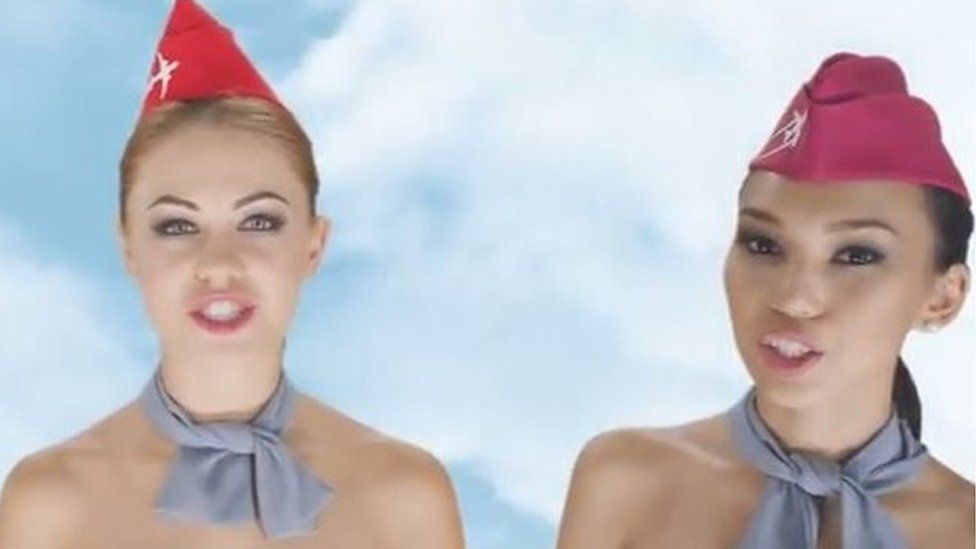 Screen shot from the video advertisement showing three naked air stewards - from the shoulders up