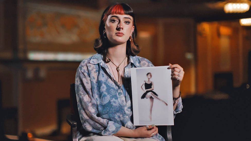 Harriet Royale holding a picture of herself in her ballerina costume