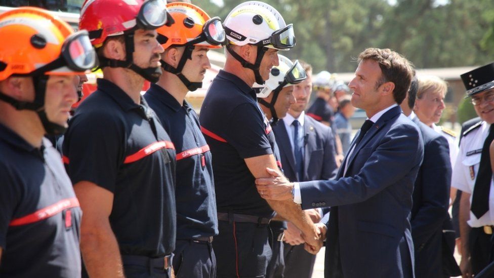 Emmanuel Macron greets firefighters at field command post in La Test-de-Buch