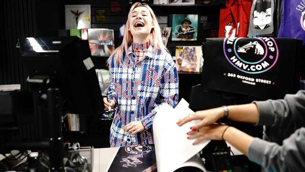 Baby Queen was signing posters for the opening