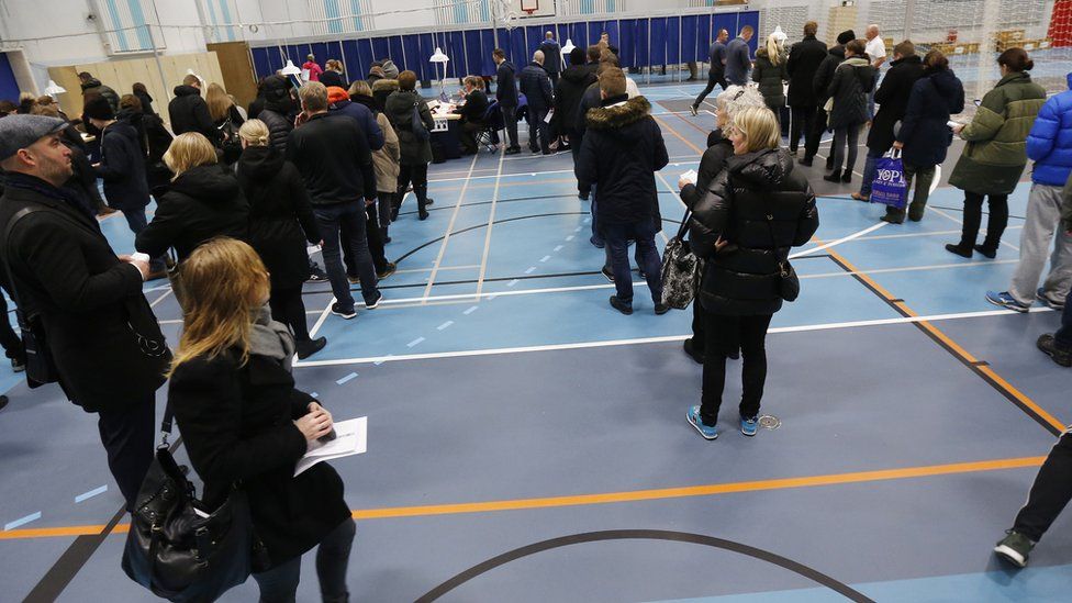 Danish voters queue up at a polling station in a Copenhagen school (3 December)