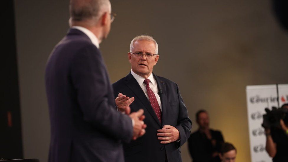 Scott Morrison speaks while looking at Anthony Albanese