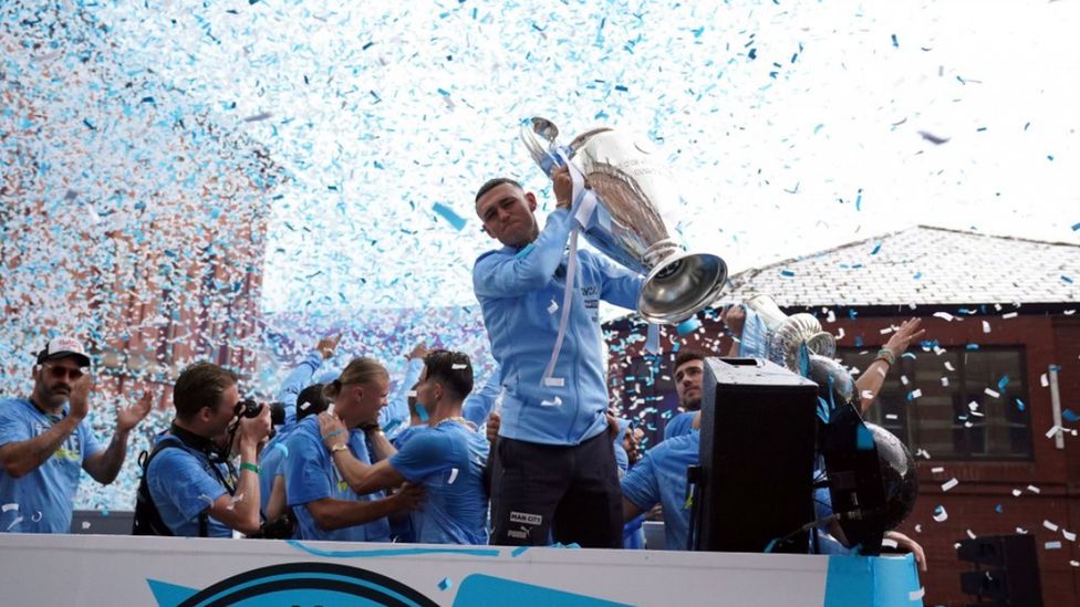Phil Foden shows off the Champions League trophy