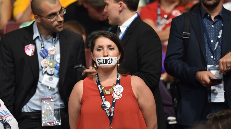 Woman silently protests with tape over her mouth