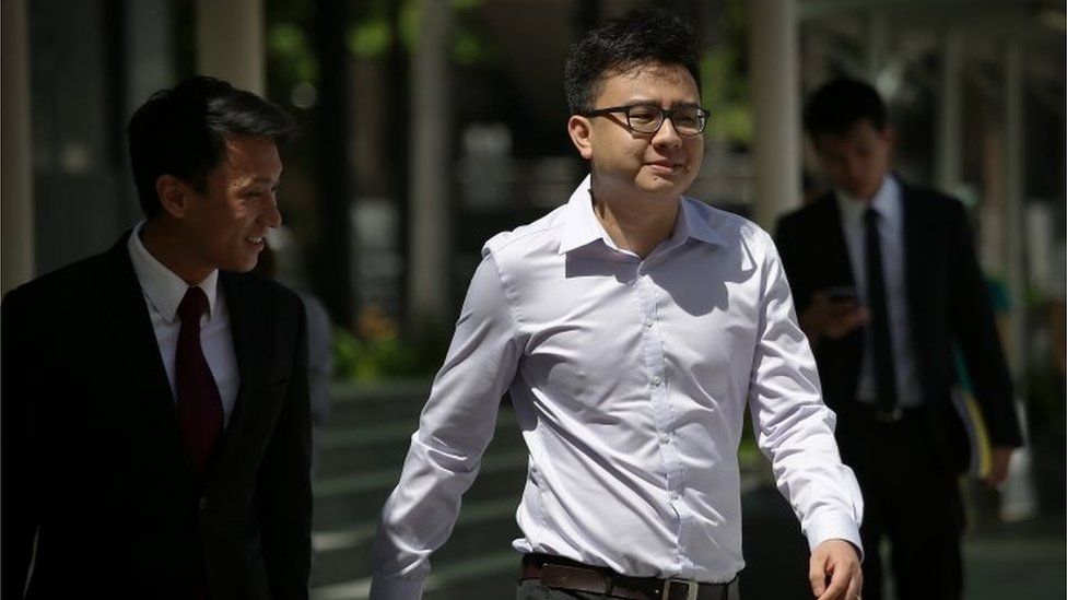 Yang Kaiheng, 27, co-founder of "The Real Singapore" website, right, arrives with his lawyer Choo Zheng Xi, left, at the State Court on Tuesday, June 28, 2016, in Singapore.