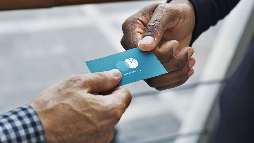 A man giving out his business card