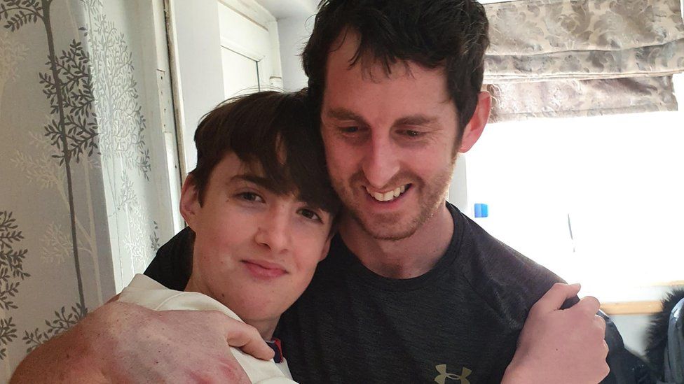 Stephen Landon hugging his son