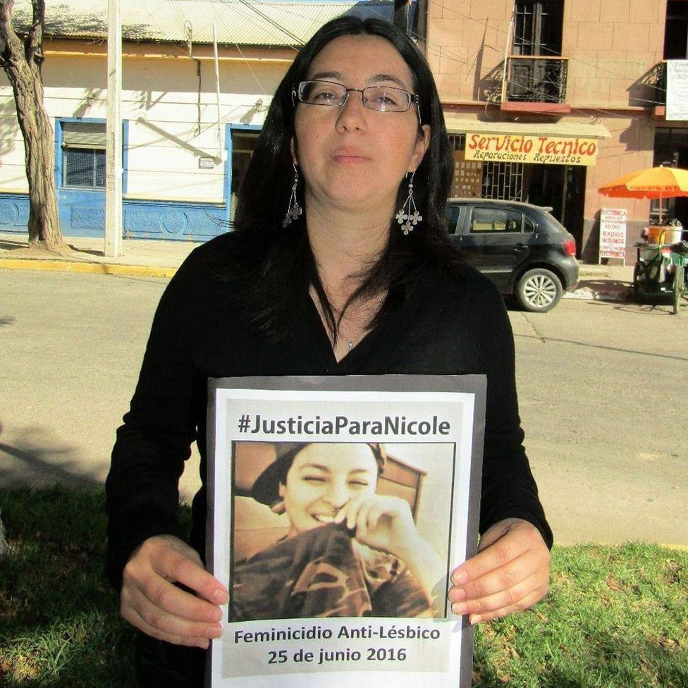 Nicole Saavedra Bahamondes' cousin, María, holding poster demanding justice for Nicole