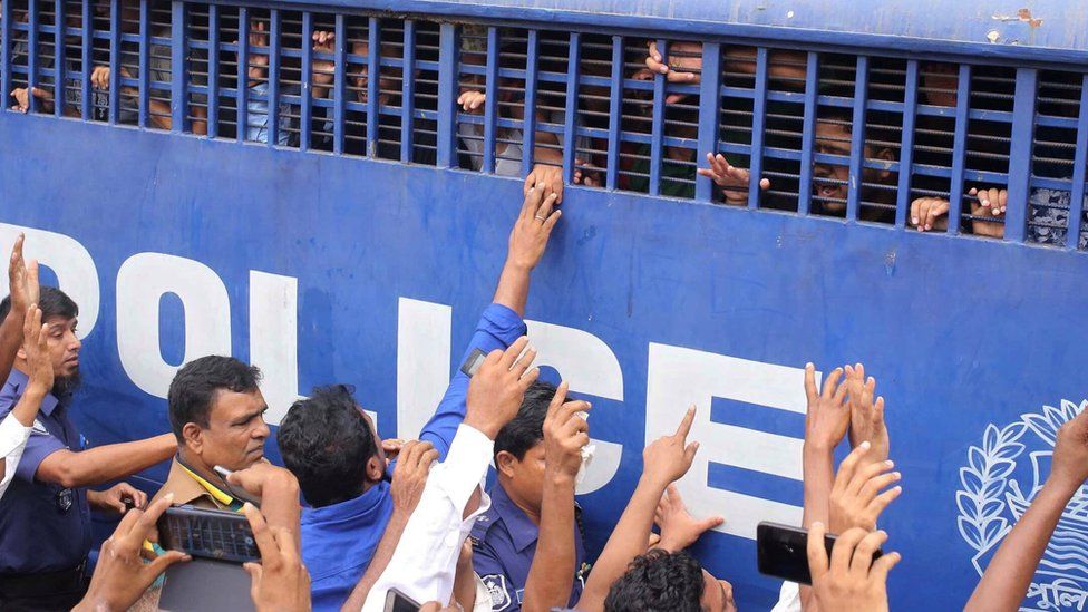 Accused people are seen inside a prison van after they were given death sentences in a murder case in Feni, Bangladesh