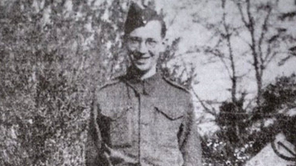 Dennis Lanham in his military uniform in a black and white photograph