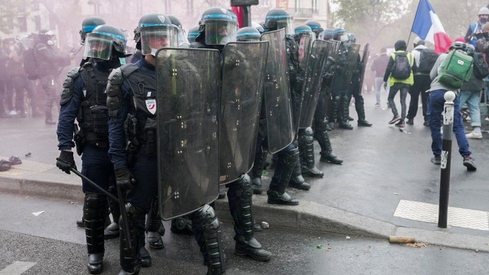 French riot police stand in formation during clashes with protesters in France