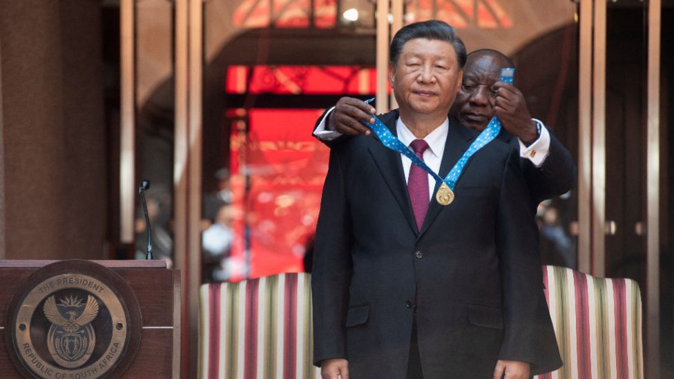 South Africa's President Cyril Ramaphosa bestows the Order of South Africa to China's President Xi Jinping ahead of the opening remarks of the Brics emerging economies meeting in South Africa.