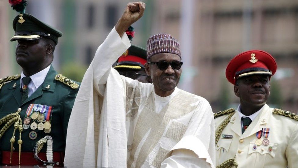 In this 29 May 2015 photo, Nigerian President, Muhammadu Buhari, salutes his supporters during his inauguration in Abuja, Nigeria