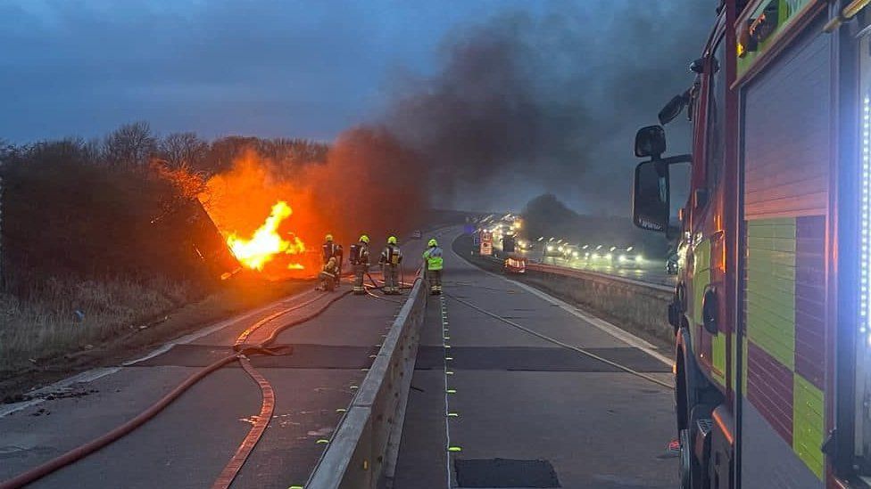 Fire crews fight a burning lorry