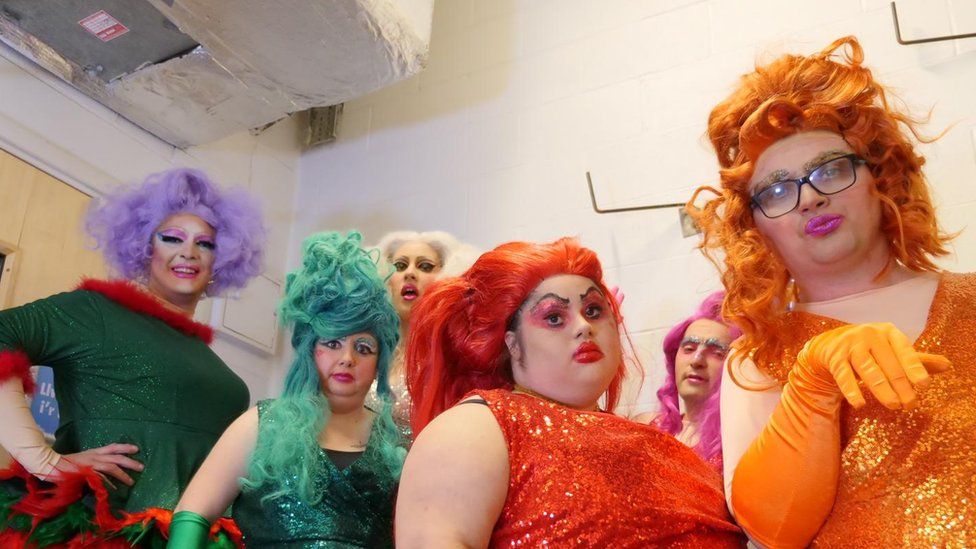 House of Deviant members in drag rainbow costumes.