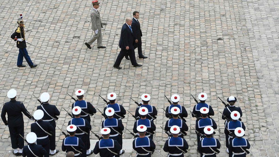 US President Donald Trump and French President Emmanuel Macron review troops during a welcome ceremony at Les Invalides in Paris, France, 13 July 2017