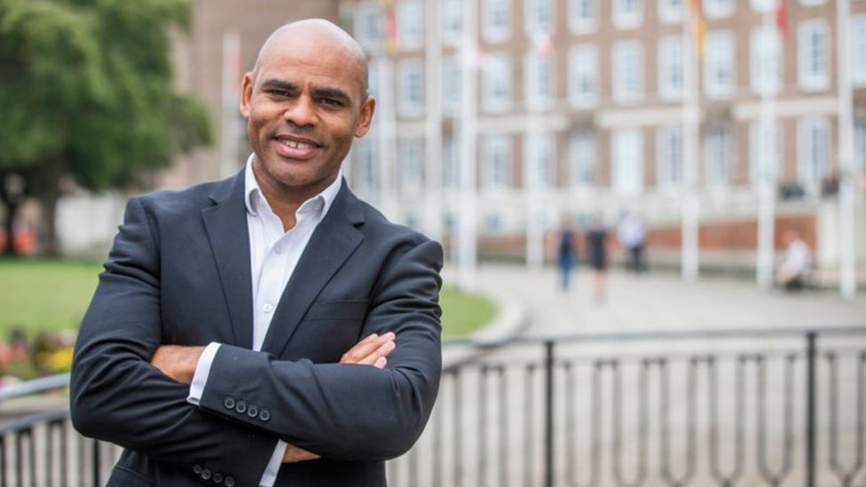 Bristol Mayor Marvin Rees posing with his arms folde4d outside City Hall