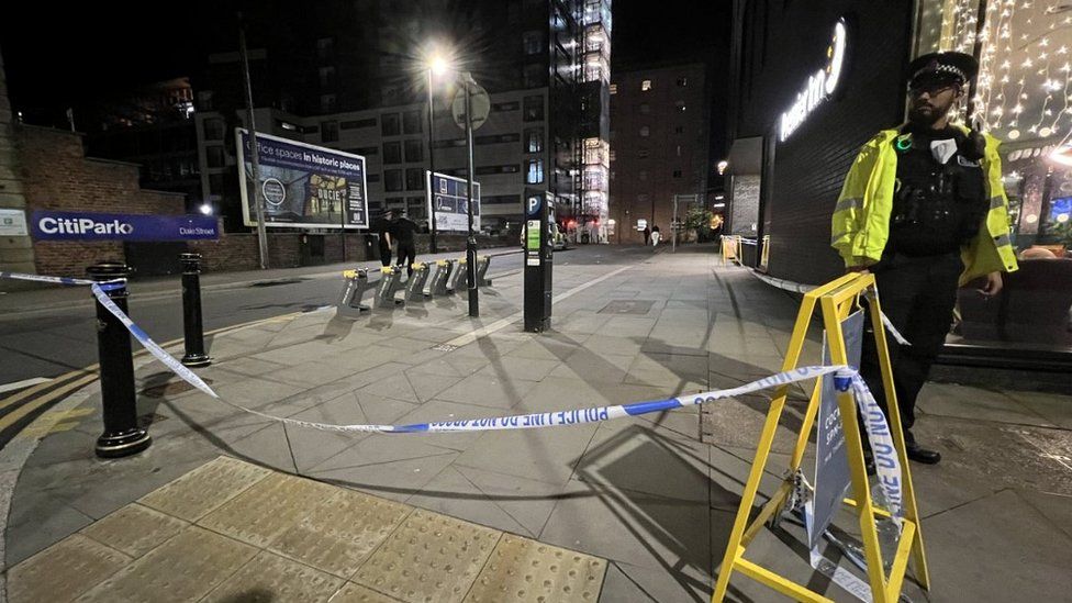 A policeman at a crime scene with police tape