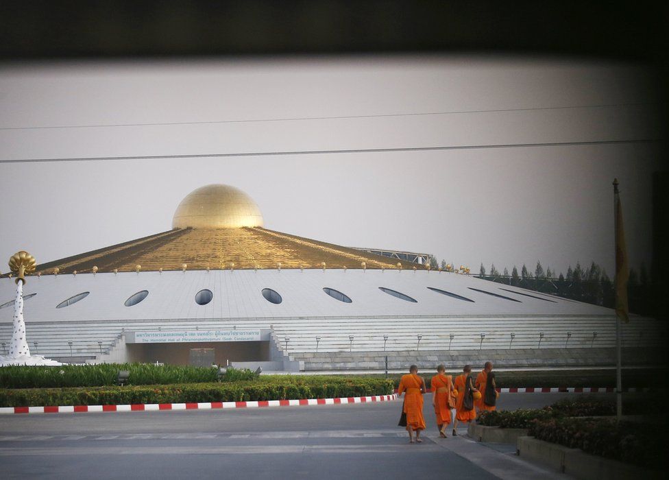 Thai Buddhist monks walk to receive morning alms law enforcement and military authorities make preperations to raid the Dhammakaya Temple in Pathum Thani province, Thailand, 16 February 2017