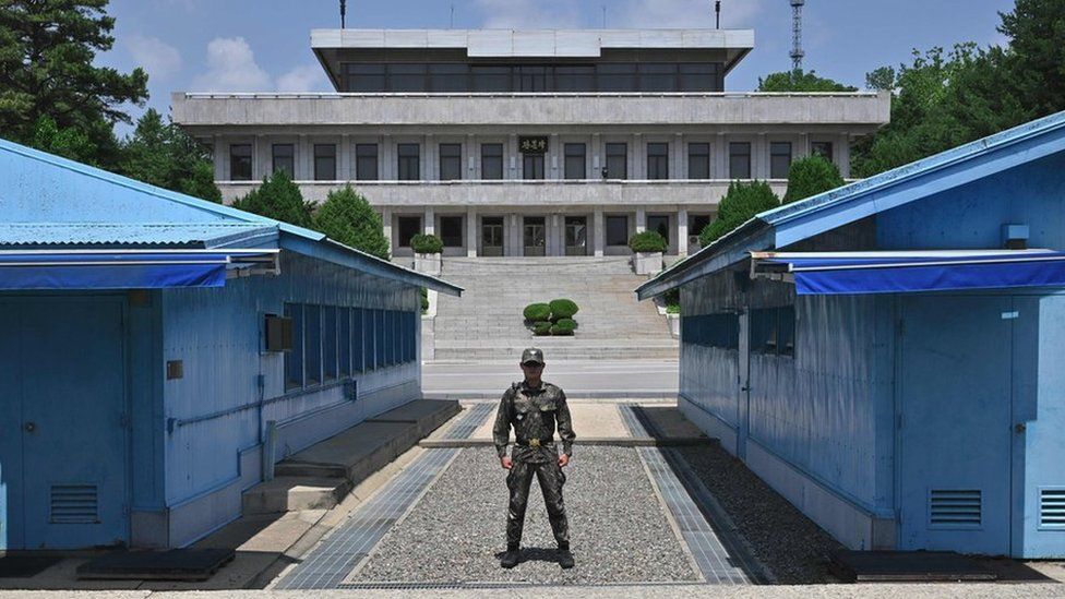 A South Korean soldier stands guard before the Military Demarcation Line (MDL) during a regular media tour at the border truce village of Panmunjom in the Demilitarised Zone