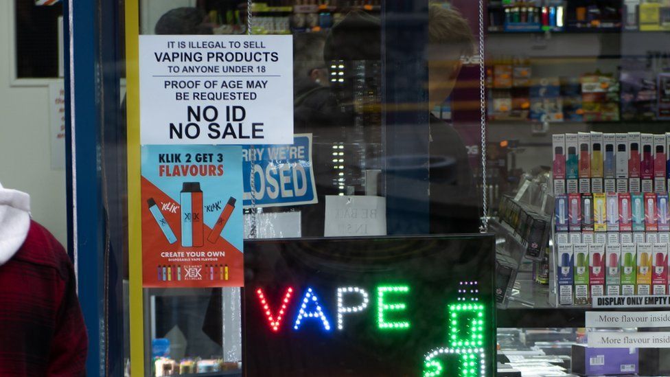Customers walk in a vape E-cigarette liquid shop