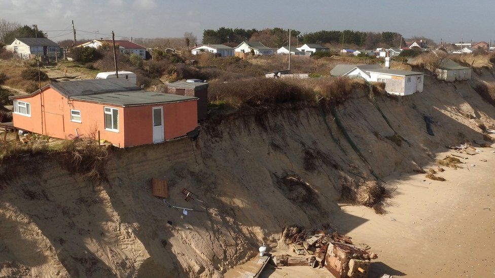 Houses sit on the cliff edge on The Marrams in Hemsby, Norfolk, in 2018