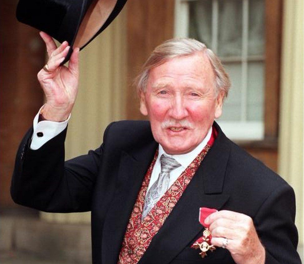 Phillips pictured outside Buckingham Palace after receiving an OBE from Queen Elizabeth II in 1998