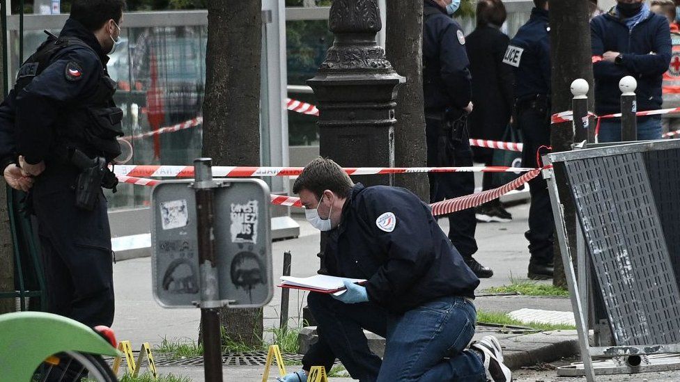 Police investigate the scene of a shooting outside a Paris hospital, 12 April 2021