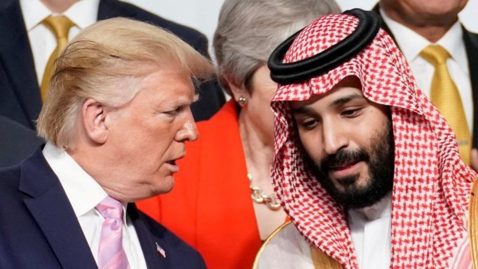 U.S. President Donald Trump speaks with Saudi Arabia's Crown Prince Mohammed bin Salman during family photo session with other leaders and attendees at the G20 leaders summit in Osaka, Japan, June 28, 2019.