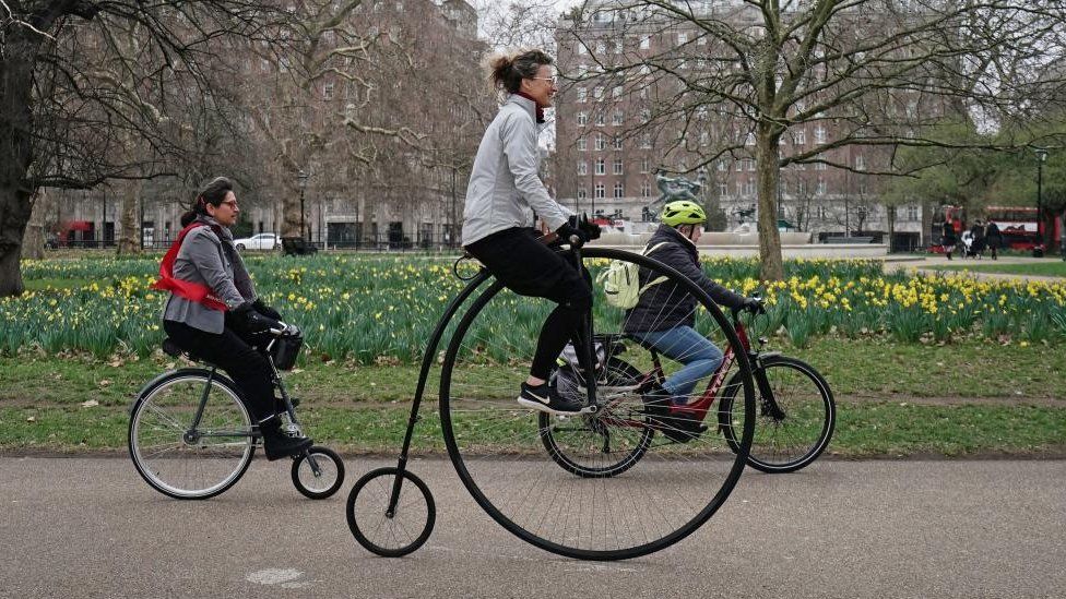 Woman on a penny farthing