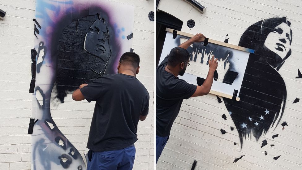 Mohammed Ali working on his mural of Ilhan Omar