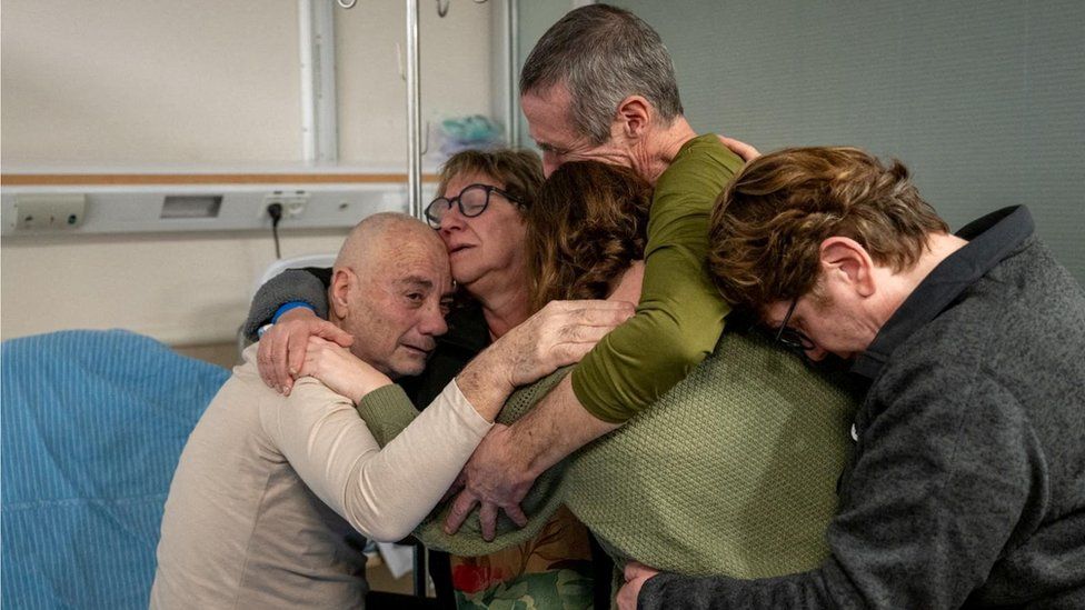 Released hostage hugs family